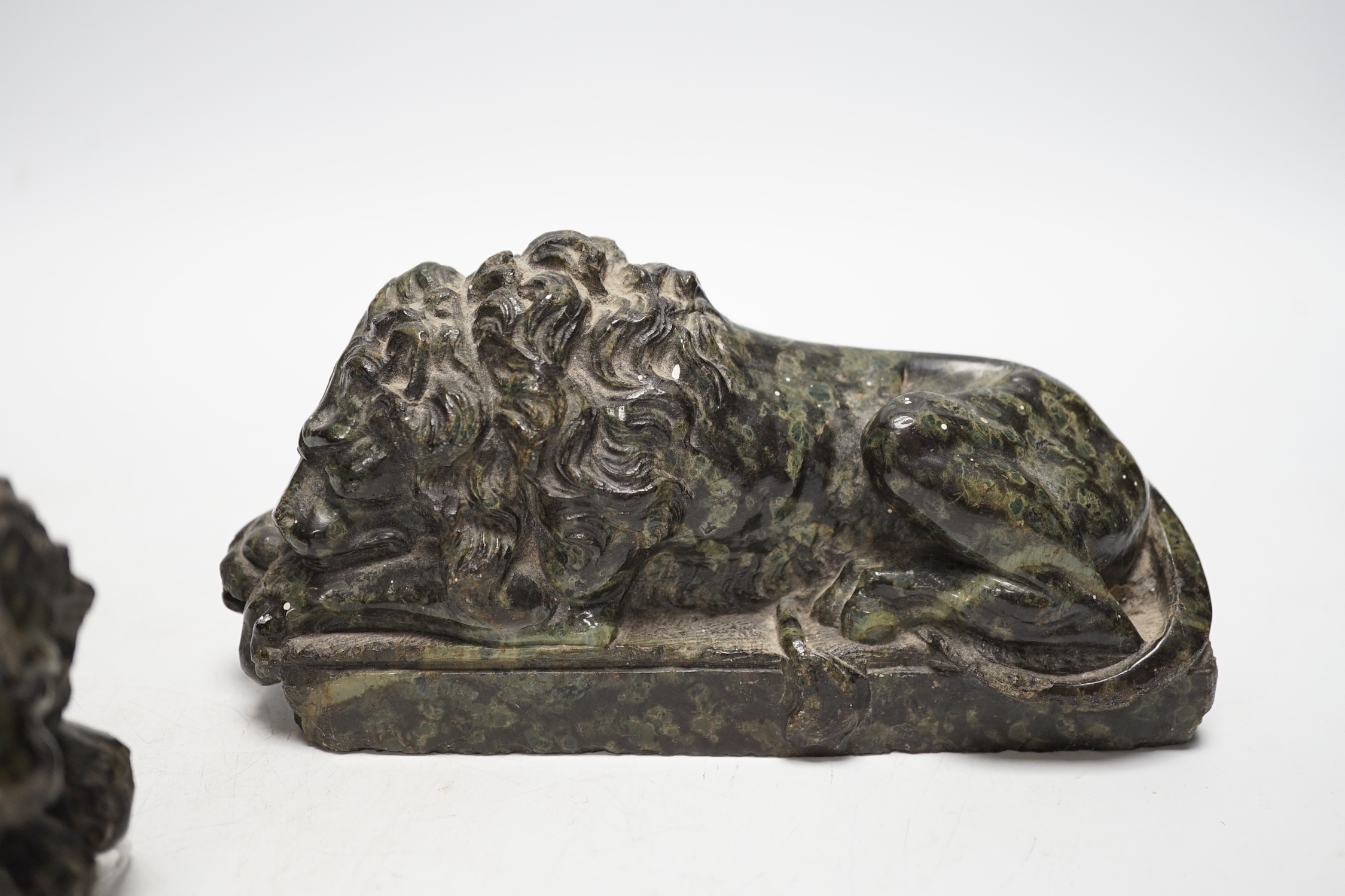 A pair of carved serpentine models of the Lucerne lions, 16cm wide